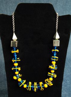 "Vintage Art Glass Necklace - Cobalt & Yellow Flame worked Glass Beads with Mexican Silver - 21\" Length - Hand Crafted by Ann Lucille Mong You will not be missed when you are wearing this stunner! Blue & Yellow Murano glass, flameworked into oblong blue coins and embellished with more yellow glass threads. Additional yellow glass round beads function as spacers, and the whole thing is strung up with Mexican sterling silver geometric beads - extending the length with sterling silver chain and a Blue Long Glass Necklace, Vintage Multicolor Glass Necklaces, Blue Murano Glass Jewelry With Colorful Beads, Blue Murano Glass Single Strand Necklace, Vintage Blue Glass Necklace, Art Glass Jewelry, Vintage Art Glass, Glass Necklace, Art Vintage