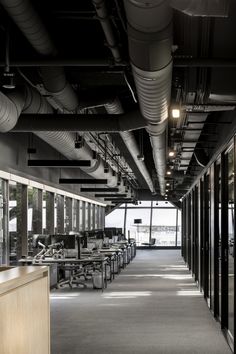 an empty office with lots of desks and chairs