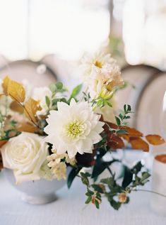 a vase filled with white flowers on top of a table