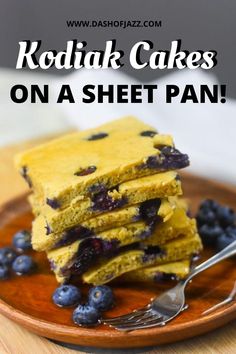 blueberry cheesecake bars stacked on top of each other with text overlay that reads, kebake cakes sheet pan blueberry protein pancakes