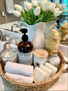 a basket filled with lots of different types of soaps and lotions next to a sink