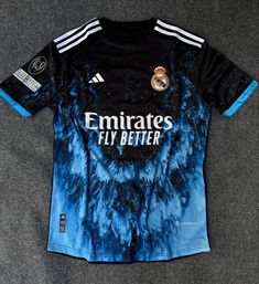 a soccer jersey with blue and black dyes on it, sitting on the floor