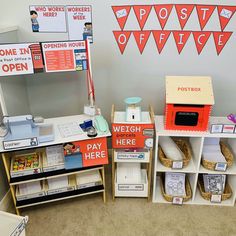 an office cubicle with various items on the desk and in front of it is a sign that says post office