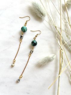 "These are long, beaded, dangle earrings featuring 10mm African Turquoise beads, brass chain, and rectangular Dalmatian Jasper beads. These unique boho earrings hang approximately 3.75\" inches from the lobe. The earwire is 18k gold plated and should be suitable if you have a metal allergy or sensitivity. These earrings are very lightweight and easy to wear. If you are not satisfied with your purchase, contact me within 14 days, and return your earrings in the original packaging for a full refun Bohemian Drop Earrings With Adjustable Chain, Long Drop Beaded Chain Earrings As Gift, Turquoise Earrings With Beaded Chain And Round Beads, Turquoise Earrings With Beaded Chain, Bohemian Style Long Drop Beaded Earrings, Turquoise Bohemian Earrings With Beaded Chain, Adjustable Dangle Earrings With Beaded Chain, Adjustable Beaded Chain Dangle Earrings, Adjustable Beaded Chain Drop Earrings