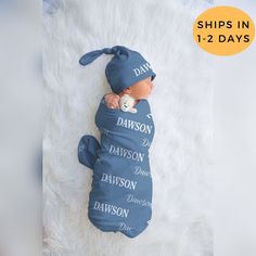 a newborn baby wrapped in a blue blanket with the words davidson written on it's side