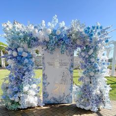 a blue and white wedding arch decorated with flowers