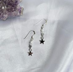 In your Folklore or Evermore era? Then these dainty star earrings are perfect for you.  Shimmering beautiful they're made of glass beads and star charms. Perfect for any Eras Tour outfit! Incredibly lightweight they're perfect for those with sensitive ears. Available in a choice of gold plated or Sterling Silver hooks, studs or as clip ons for non pierced ears. Studs are 4mm stud ball posts. All earring findings are nickel and lead free making them great for sensitive ears. Materials- Sterling S Celestial Star-shaped Crystal Earrings For Gift, Celestial Star-shaped Crystal Earrings Gift, Celestial Star-shaped Crystal Earrings, Single Star-shaped Crystal Earring As Gift, Silver Star Charm Crystal Earrings For Gift, White Star Charm Earrings As Gift, Star-shaped Crystal Earrings For Gifts, Silver Celestial Crystal Earrings As Gift, Silver Celestial Crystal Earrings For Gift