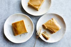 two white plates with slices of cake on them