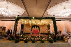 an elaborate stage set up with flowers and greenery for a wedding or party event