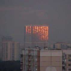 an image of a city skyline with buildings in the back ground and lights on top