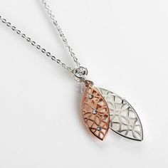 Equilibrium Two Tone Filigree Ornate Duo Necklace
Add a sense of class and elegance to any outfit with this beautiful piece of jewellery from Equilibrium.
This delicate necklace showcases a duo of ornate filigree leaves. One polished rose-gold filigree leaf, with dainty gemstones, sits on top of a larger polished silver filigree leaf. The leaf pendant hangs from a single gemstone on the silver chain. The stylish pendant hangs from a silver chain which is approximately 45cm in length which fastens with a clip and loop mechanism. There is also a 5cm extension chain which allows you to adjust the length to your liking.
Presented in a gift box which branded with the Equilibrium logo, the box features the text ‘Filigree Collection, Stand out in the crowd with simple yet elegant filigree jewelle Duo Necklace, Gold Filigree, Leaf Pendant, Silver Filigree, Top Gifts, Delicate Necklace, Matching Earrings, Silver Chain, Two Tone