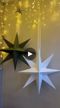 two paper stars hanging from the ceiling next to each other