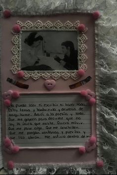 a photo frame with pink pom - poms around it and a poem written in spanish