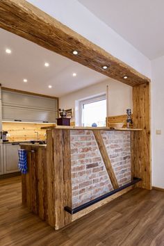 a kitchen with an island made out of wood and brick in the middle of it