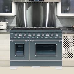 a stove top oven sitting inside of a kitchen