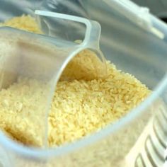 rice is being mixed in a plastic container