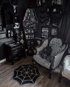 a black and white living room with spider web rugs on the hardwood flooring