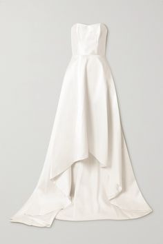 the back of a white dress with an asymmetrical skirt