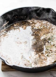 a skillet with some food cooking in it