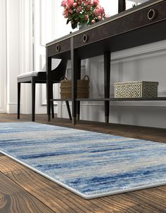 a blue rug on the floor in front of a table