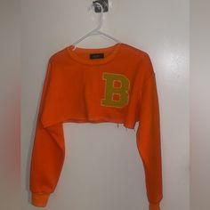 Orange Sweater Crop With Yellow B Embroidered. Cute Casual Wear Fitted Cropped Sweatshirt For Spring, Yellow Cropped Cotton Crop Top, Yellow Cropped Tops For Fall, Cropped Yellow Tops For Fall, Orange Long Sleeve Top For College, Long Sleeve Orange Tops For College, Trendy Yellow Long Sleeve Crop Top, Fitted Yellow Crop Top For Fall, Trendy Yellow Crew Neck Crop Top