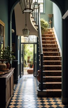 an entry way with stairs and potted plants