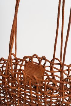 A tote that epitomizes modern style with its unique fishnet weaving crafted from full leather round lace. This bag offers a spacious interior, making it suitable for both daily use and special occasions. Designed to be worn comfortably on the shoulder, the NS Kanpur is perfect for those who appreciate a contemporary look combined with the timeless appeal of leather craftsmanship. 100% Buffalo Leather Unlined Handwoven in India Modern Bags With Leather Handles For Market, Luxury Leather Basket Bucket Bag, Leather Basket Shoulder Bag With Adjustable Strap, Top Handle Open Weave Shoulder Bag For Shopping, Woven Leather Bucket Bag For Market, Natural Leather Basket Bucket Bag, Natural Leather Basket-shaped Bucket Bag, Modern Woven Leather Bucket Bag For Daily Use, Leather Woven Bucket Bag For Daily Use