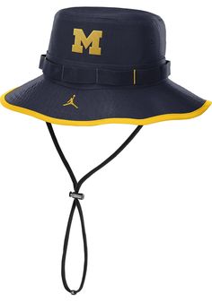 Cheer on your favorite team with this Michigan Wolverines Navy Blue Bucket Hat. This hat features a team logo on front, and is designed for a comfortable, all-day fit. Go Michigan! Nike Core Bucket, Front embroidered team logo, Embroidered Swoosh logo, Nike Dri-Fit performance material, Crushable and packable for easy use, All-around visor for sun protection, Polyester, Wipe clean with cloth or cleaning kit, 4 Adjustable Team Logo Cap, Navy Sporty Hat For Sports, Sporty Bucket Hat With Curved Brim For Sports, Adjustable Navy Sports Hat, Sporty Bucket Hat With Curved Brim, Navy Curved Brim Hat For Game Day, Sporty Adjustable Bucket Hat, Adjustable Sporty Bucket Hat, Team-colored Adjustable Hat With Curved Brim