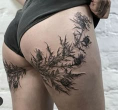 a woman's thigh with flowers on it