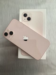 two new iphones are sitting next to each other in their packaging boxes on a table