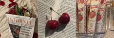 there are three cherries hanging on the wall next to newspaper pages and vases with flowers in them