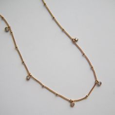 The Lola Satellite Necklace is a beautiful piece that features a delicate satellite chain and dainty CZ dangles. Elevate any outfit with this versatile accessory. - stainless steel, gold plated - 16" in length with 2" extender Dainty Adjustable Charm Necklaces With Satellite Chain, Gold Plated Charm Necklace With Satellite Chain, Dainty Gold-plated Charm Necklace With Satellite Chain, Dainty Gold Plated Charm Necklace With Satellite Chain, Dainty Gold Plated Drop Necklace With Delicate Chain, Satellite Necklace, Jewelry Case, Pearl Ring, Pearl Jewelry