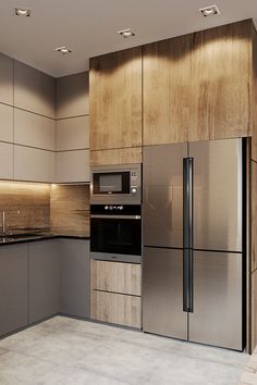 a modern kitchen with stainless steel appliances and wood paneled walls, along with marble flooring