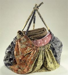 four purses stacked on top of each other with straps hanging from the handles, all in different colors and patterns