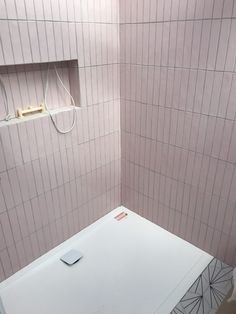 a white bath tub sitting next to a shower head