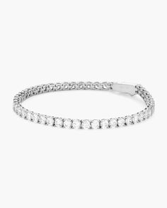 We are pleased to introduce you to our silver Tennis Bracelet—serving classic luxury with stunning simulated diamonds handset in a silver chain. Made to be worn for every occasion. Classic Sterling Silver Bracelet With Prong Setting, Fine Jewelry Silver Tennis Bracelet For Everyday Luxury, Classic White Gold Chain Bracelet With Diamond Accents, Classic Silver Cubic Zirconia Tennis Bracelet, Timeless Silver Diamond Chain Bracelet, Timeless Cubic Zirconia Chain Bracelet For Anniversary, Timeless Sterling Silver Diamond White Bracelet, Classic Silver Tennis Bracelet With Prong Setting, Silver Diamond Cut Tennis Bracelet For Everyday Luxury