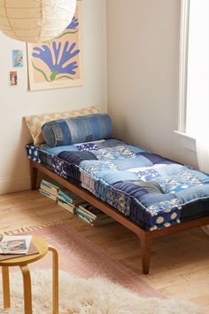 a bed sitting in the middle of a room next to a window