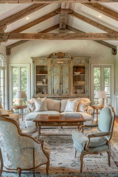 a living room filled with furniture and lots of windows