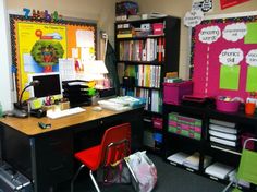 an office with desk, chair and bookshelf full of colorful binders on the wall