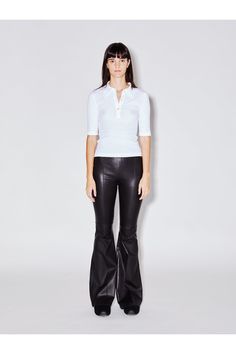 Cut to flatter and elongate the body, this ultra-soft leather pant has a mid-rise, flared-leg silhouette. Pintuck seaming down the front lengthens further, while the elasticized waist enhances the ease of wear  imparting a relaxed sensibility to the otherwise luxe style. The center point of Rosetta Gettys popular leather offering, this Stretch Plongé fabric pairs buttery-soft lambskin with a stretch cotton backing for a leisurely feel. Tanned in France, it has a sexy, slightly shiny finish while Modern Fitted Wide Leg Leather Pants, Fitted Flare Leather Pants For Work, Elegant Flare Leather Pants, Stretch Leather Wide Leg Pants, Elegant Flared Leather Pants, Fitted Wide Leg Leather Pants, Cropped Flare Pants, Luxe Style, Center Point