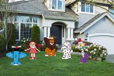 lawn decorations in front of a house with cartoon characters on the lawn and an umbrella