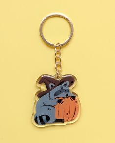 a keychain with an image of two animals in the shape of a pumpkin