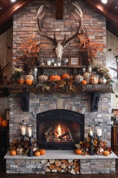 the fireplace is decorated with pumpkins and deer heads