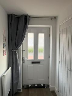 a white door with black curtains in front of it