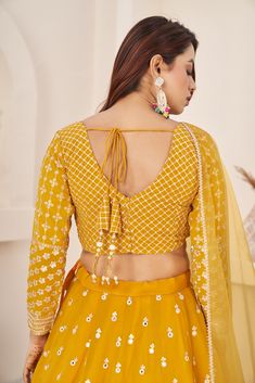 This is a 3-piece set. The set consists of sleeveless blouse with sequins & zari detailing, round neck teamed with flared matching lehenga and a dupatta. No of piece - 3 piece Color- Yellow Fabric-Georgette Dupatta Fabric - Georgette Blouse Sleeves-Sleeveless Neck-Round Neck Lehenga length: Floor Length Washing instructions: Dry Clean Work- Zari & Sequins Print Detailing. Flared lehenga Comes with Dupatta Customizations: available. Please add your measurements in the 'order notes' box during checkout. Model with height is wearing size Small. Matching Lehenga, Stylish Lehenga, Haldi Wear, Flared Lehenga, Lehenga Crop Top, Georgette Material, Bridesmaid Lehenga, Georgette Lehenga, Indian Lehenga Choli