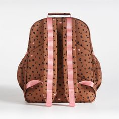 A backpack that's extra comfy and ready to handle a day in the wild. Patterned with cheetah spots and light pink hearts on a tawny brown background, the kids' large knapsack is constructed of supremely durable polyester made from recycled water bottles. A roomy interior holds everything your kid needs-books, school supplies, extra layers-and there's a padded pocket to keep their tablet protected. Outside pockets hold snacks, water bottles and more. For an adventurous combination, pair this book Adjustable Brown School Bags, Cute Brown Backpack For Back To School, Brown School Bag With Adjustable Straps, Playful Brown School Bag, Cute Brown Backpack For School, Cute Brown School Backpack, Cute Brown Travel Backpack, Cute Brown Standard Backpack, Tawny Brown