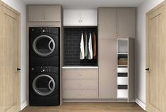 a washer and dryer in a small room with cabinets on either side of it