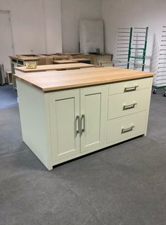 an unfinished kitchen island with drawers in the middle