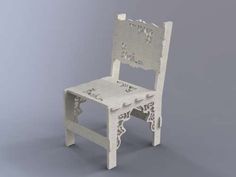 a white chair that is sitting on a gray surface and has an intricately carved seat