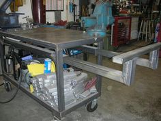 a metal workbench with lots of items on it